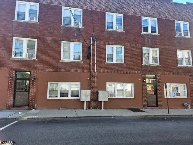 a kitchen with granite countertop a sink stove and cabinets