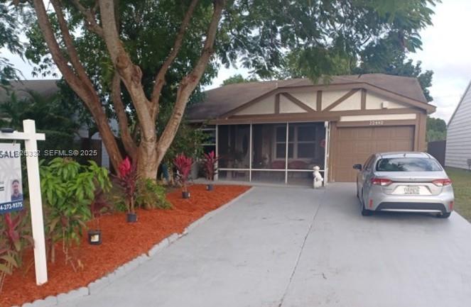 a front view of a house with a garden and trees