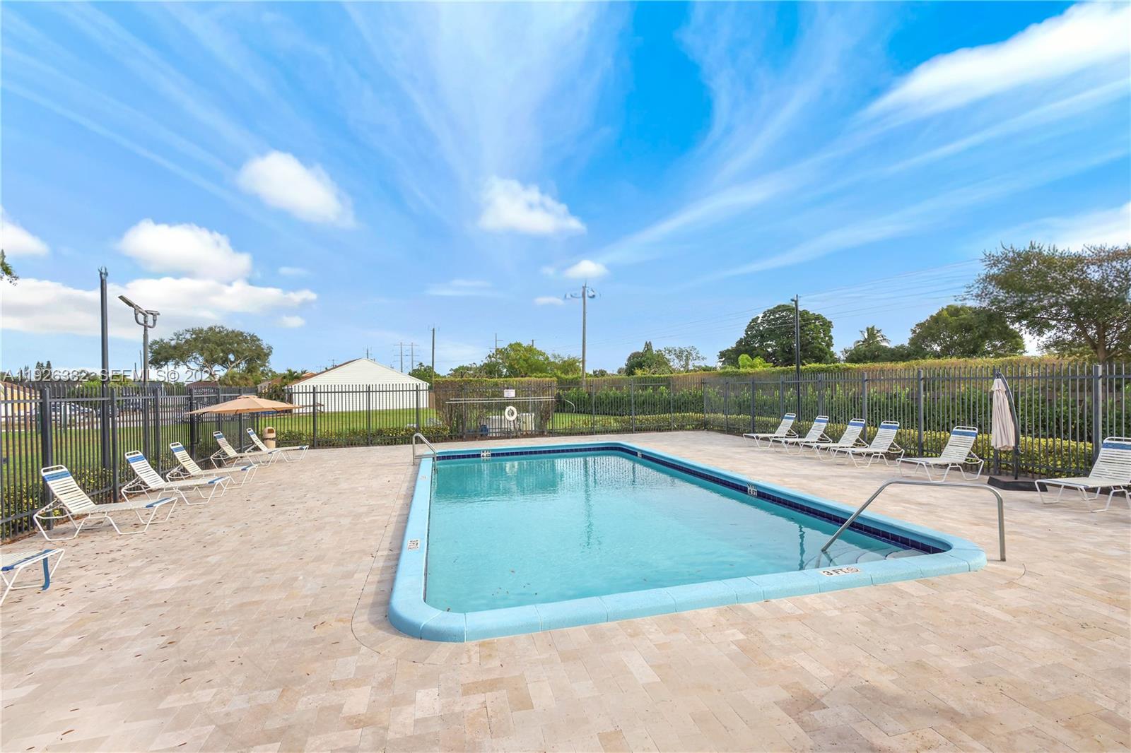 22882 Markham Way Boca Raton, FL 33428 - Photo 12 of 16 a view of a swimming pool with a lounge chairs
