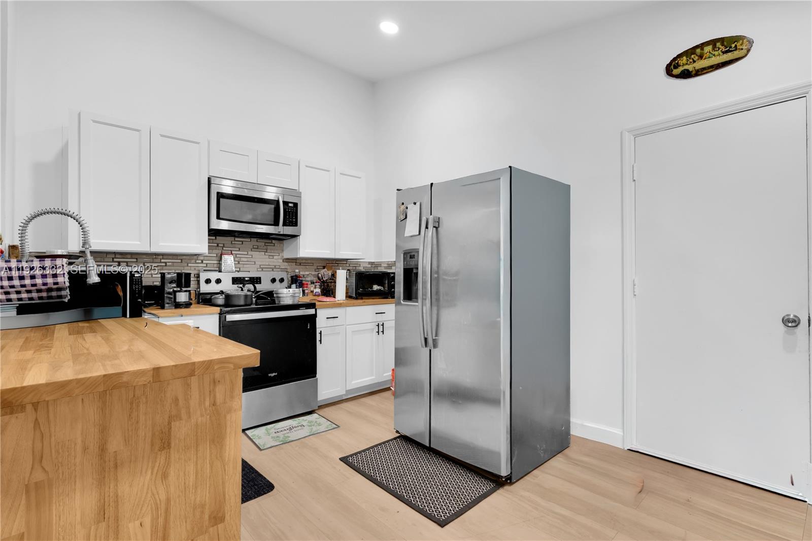 22882 Markham Way Boca Raton, FL 33428 - Photo 6 of 16 a kitchen with stainless steel appliances a refrigerator sink and microwave