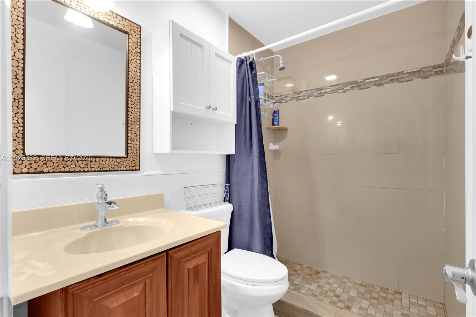 22882 Markham Way Boca Raton, FL 33428 - Photo 8 of 16 a bathroom with a sink a toilet a mirror and shower