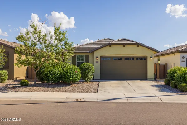 a front view of a house with a yard and garage