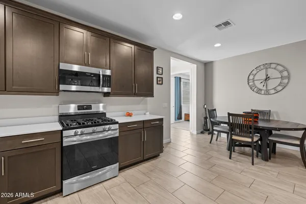 a large kitchen with lots of counter and chairs