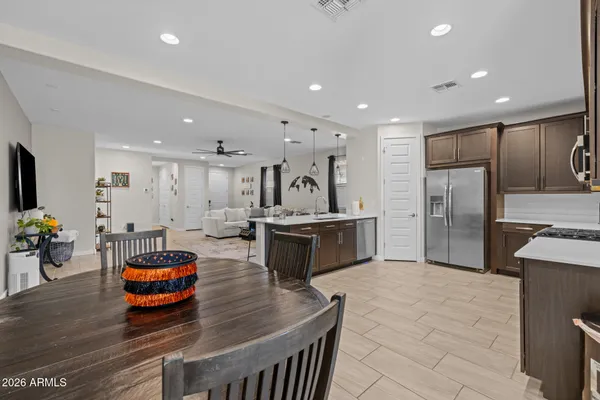 a kitchen with stainless steel appliances granite countertop a stove a sink a microwave and dining table