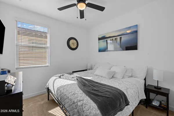 a bathroom with a double vanity sink a toilet a mirror and shower