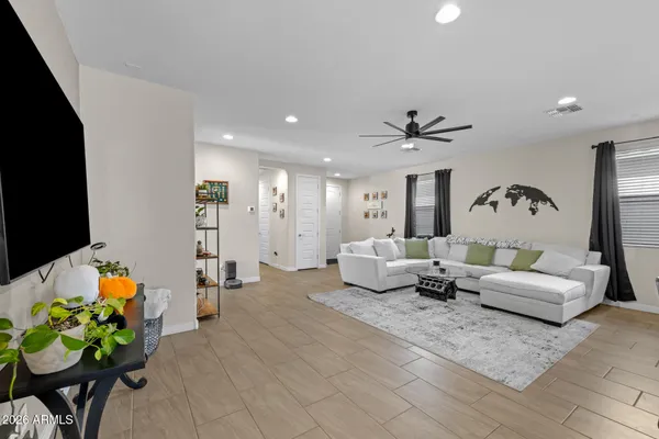 a living room with furniture and kitchen view