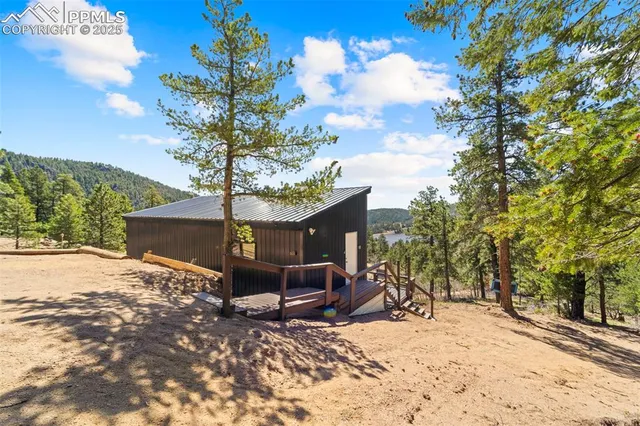 a bathroom with a sink a toilet mirror and shower