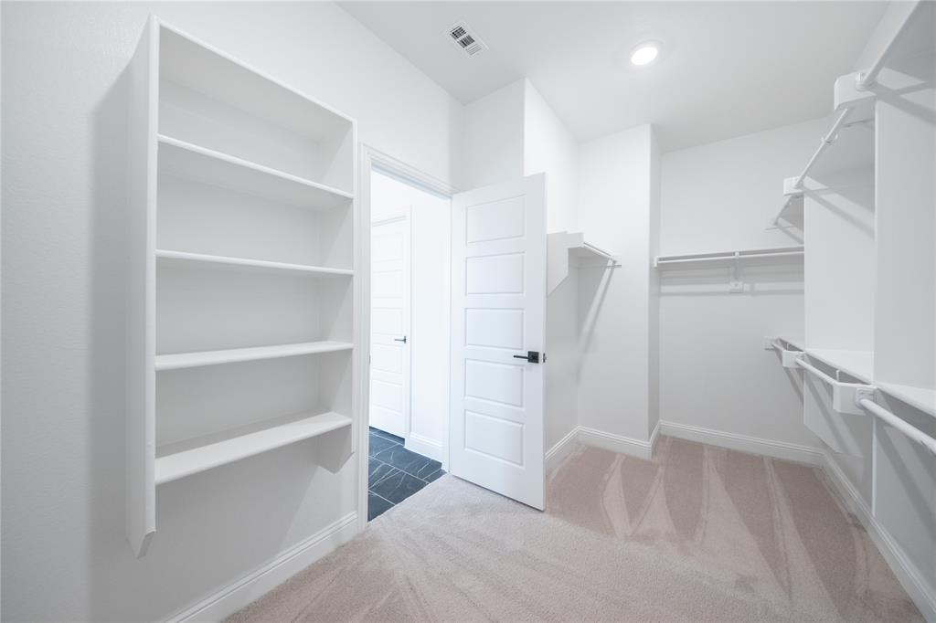 2405 St George Drive Celina, TX 75009 - Photo 12 of 30 a bathroom with a bathtub and closet