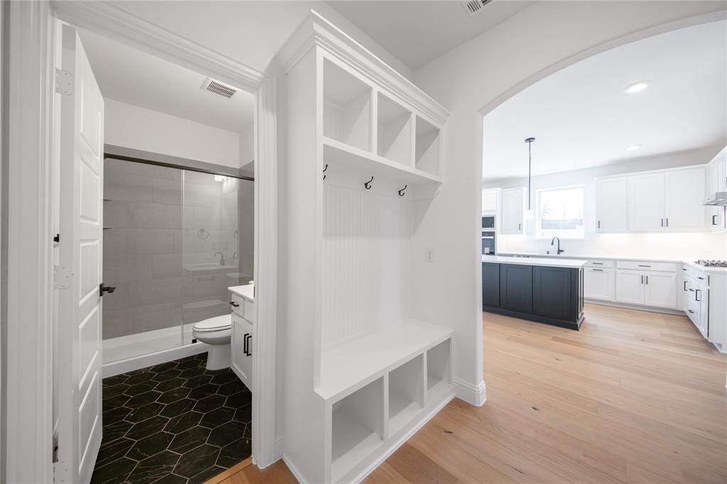 2405 St George Drive Celina, TX 75009 - Photo 18 of 30 a bathroom with a double vanity sink a toilet and a shower