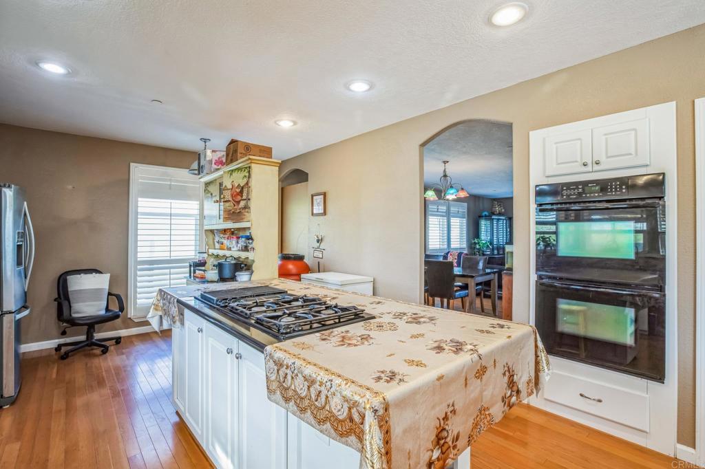 735 Swedes Flat Road Oroville, CA 95966 - Photo 4 of 37 a large kitchen with a stove and a wooden floor