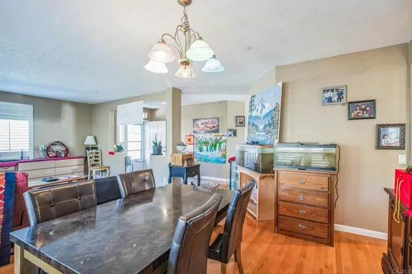 a view of a dining room with furniture and a chandelier