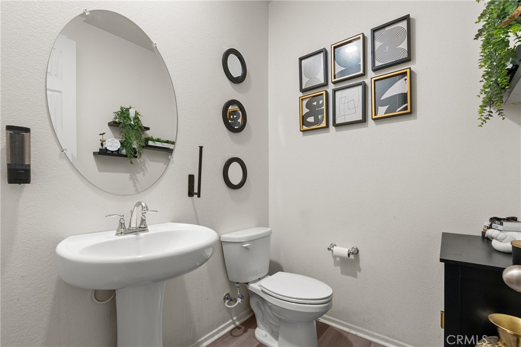 6949 Beale Road Palmdale, CA 93552 - Photo 14 of 32 a bathroom with a toilet sink and mirror