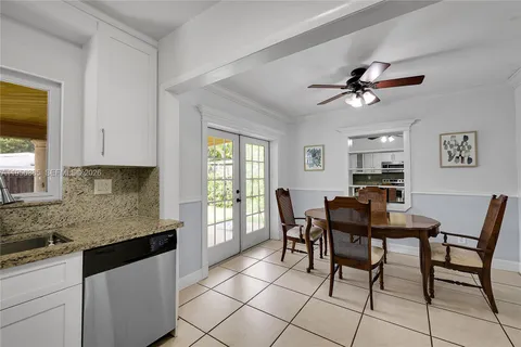 a view of a dining room with furniture and a window