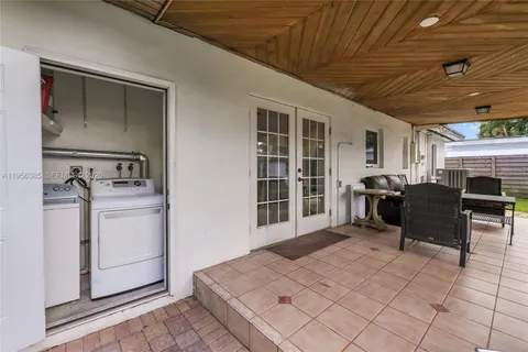 a room with furniture a washer and dryer