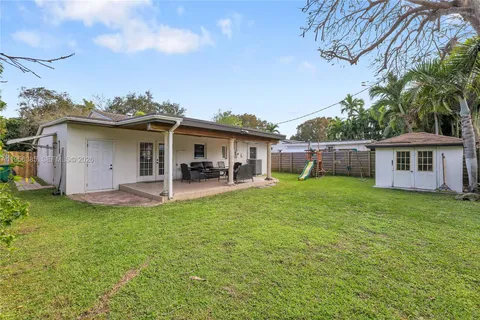 a view of a house with a backyard and a patio