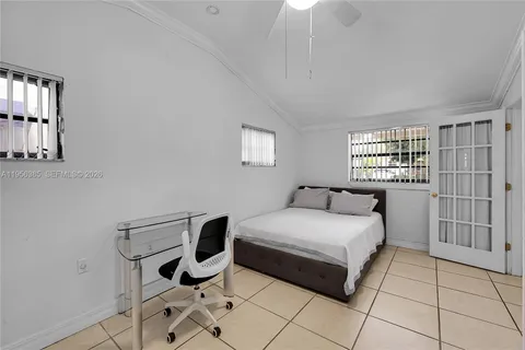 a bedroom with a bed a table and chair