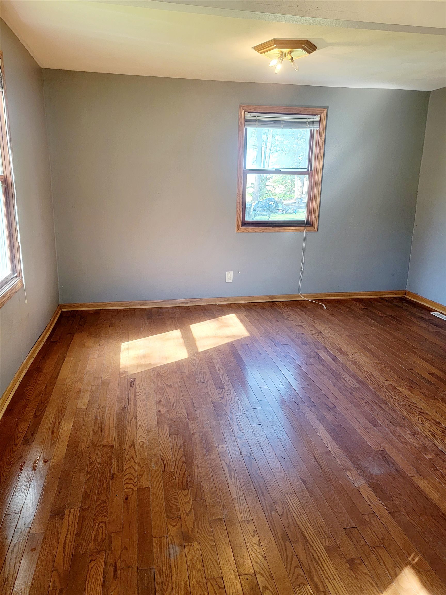 8014 South Creek Road Beloit, WI 53511 - Photo 20 of 39 an empty room with wooden floor and windows