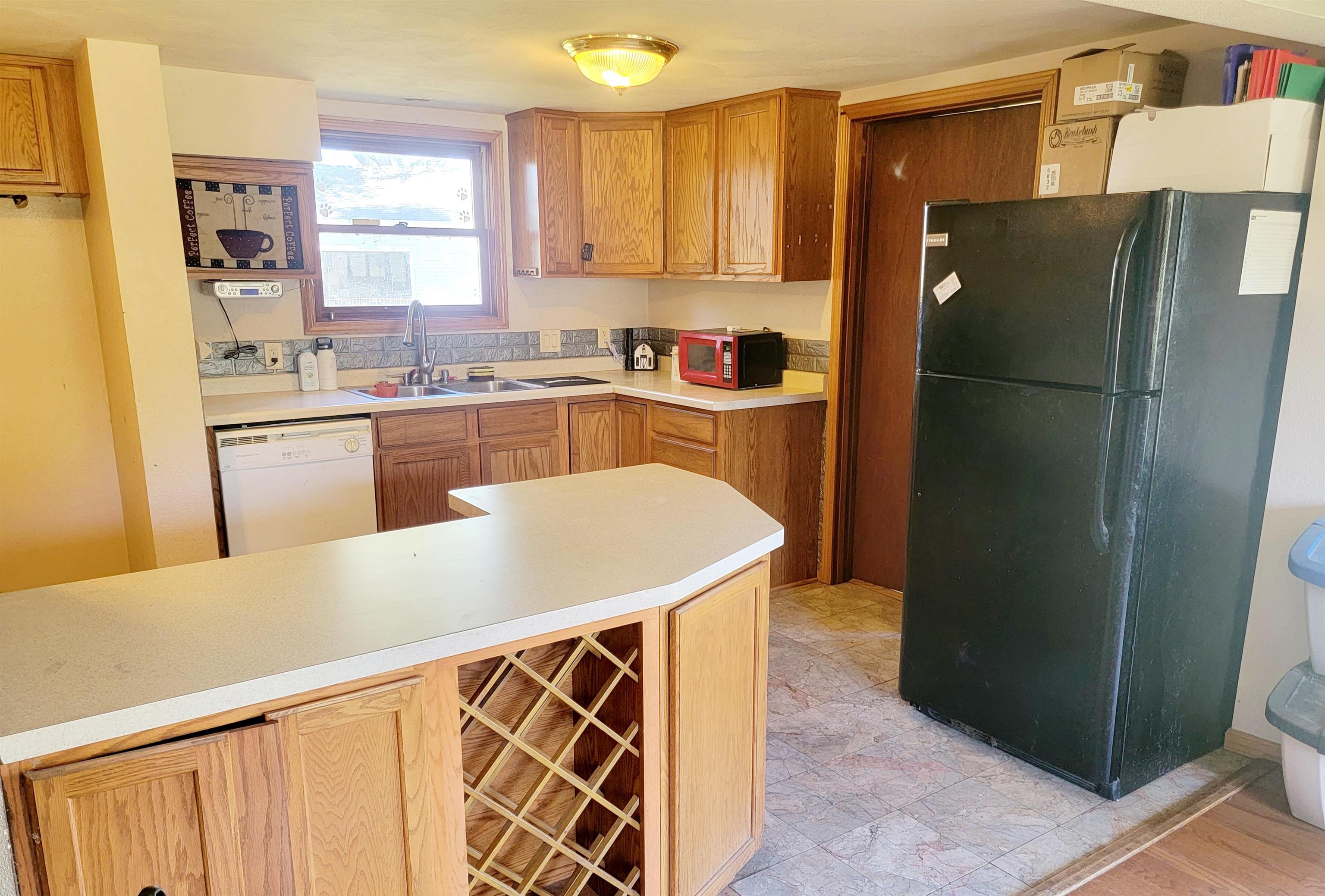 8014 South Creek Road Beloit, WI 53511 - Photo 21 of 39 a kitchen with granite countertop a refrigerator and a sink