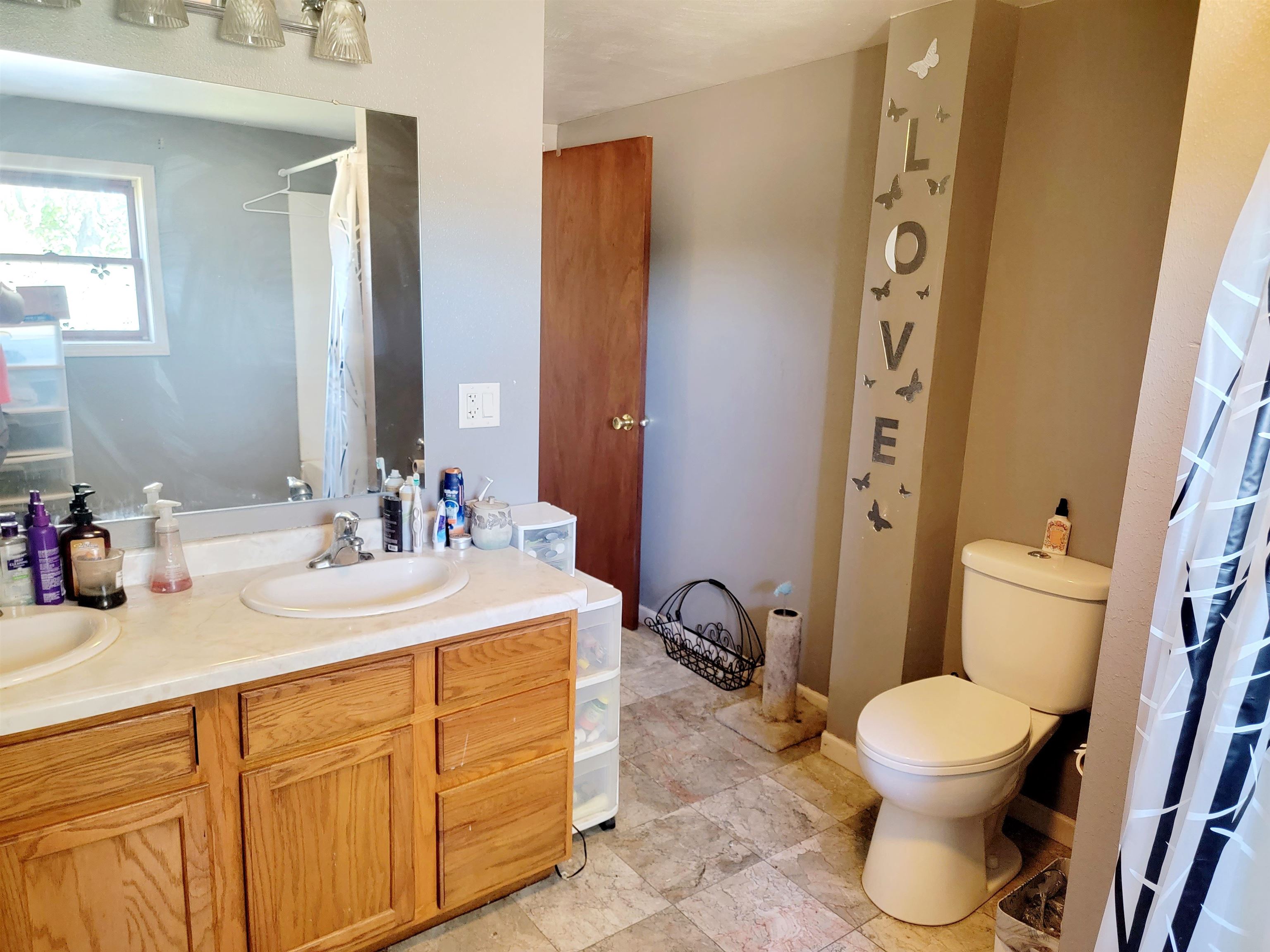8014 South Creek Road Beloit, WI 53511 - Photo 27 of 39 a bathroom with a toilet sink and mirror