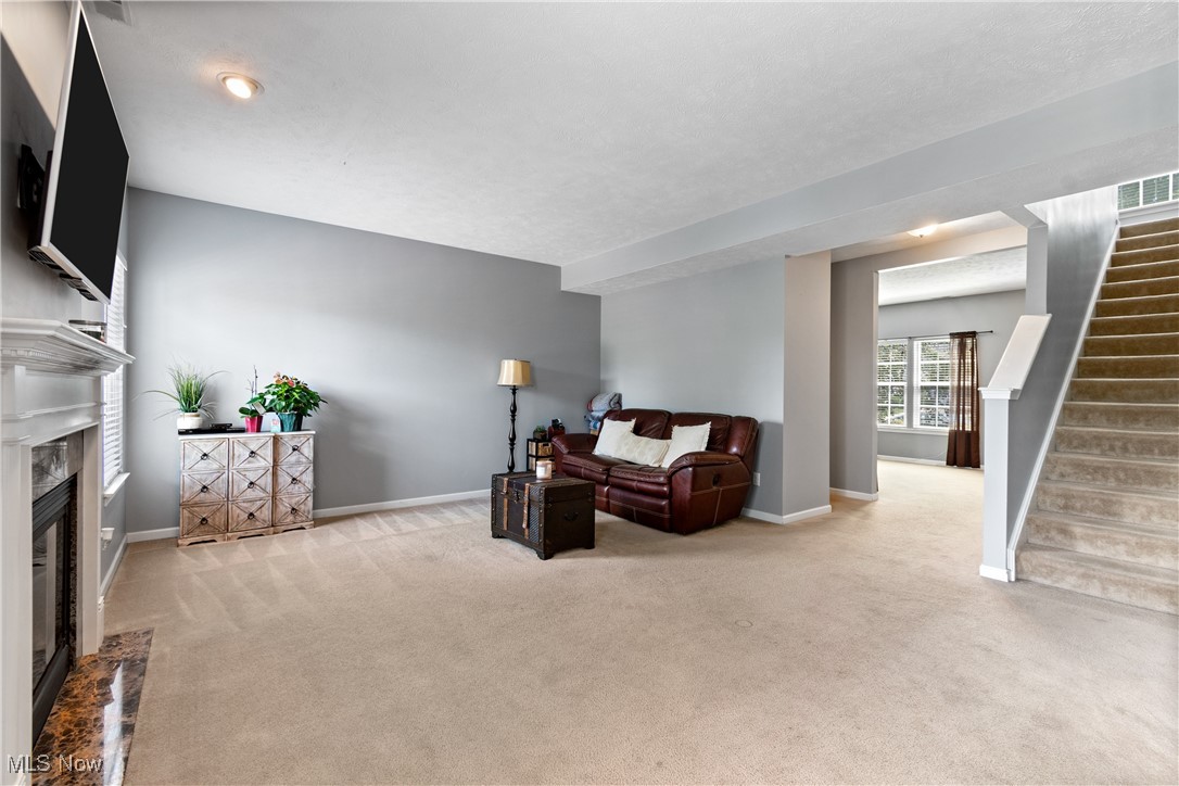 4467 Ridgestone Way Medina, OH 44256 - Photo 5 of 31 Carpeted living room with a fireplace