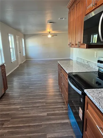 a kitchen with granite countertop a sink and a stove