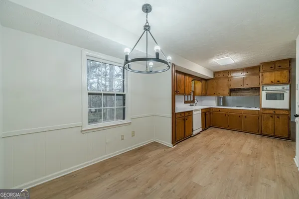 a kitchen with stainless steel appliances a sink and window