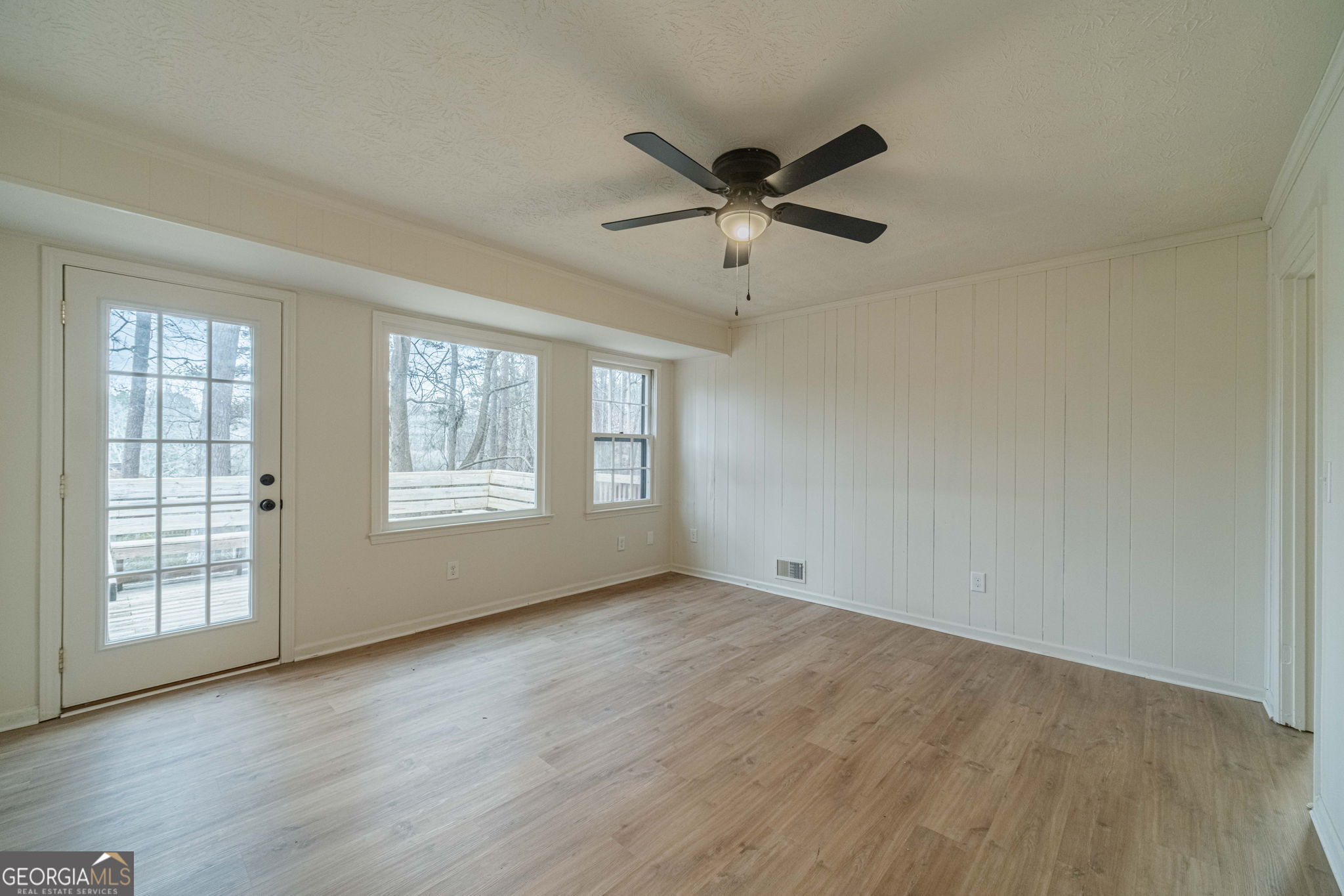 1678 Pounds Road Southwest Stone Mountain, GA 30087 - Photo 13 of 30 a view of an empty room with wooden floor and a window