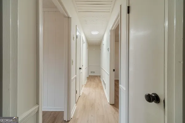 a view of a hallway with wooden floor