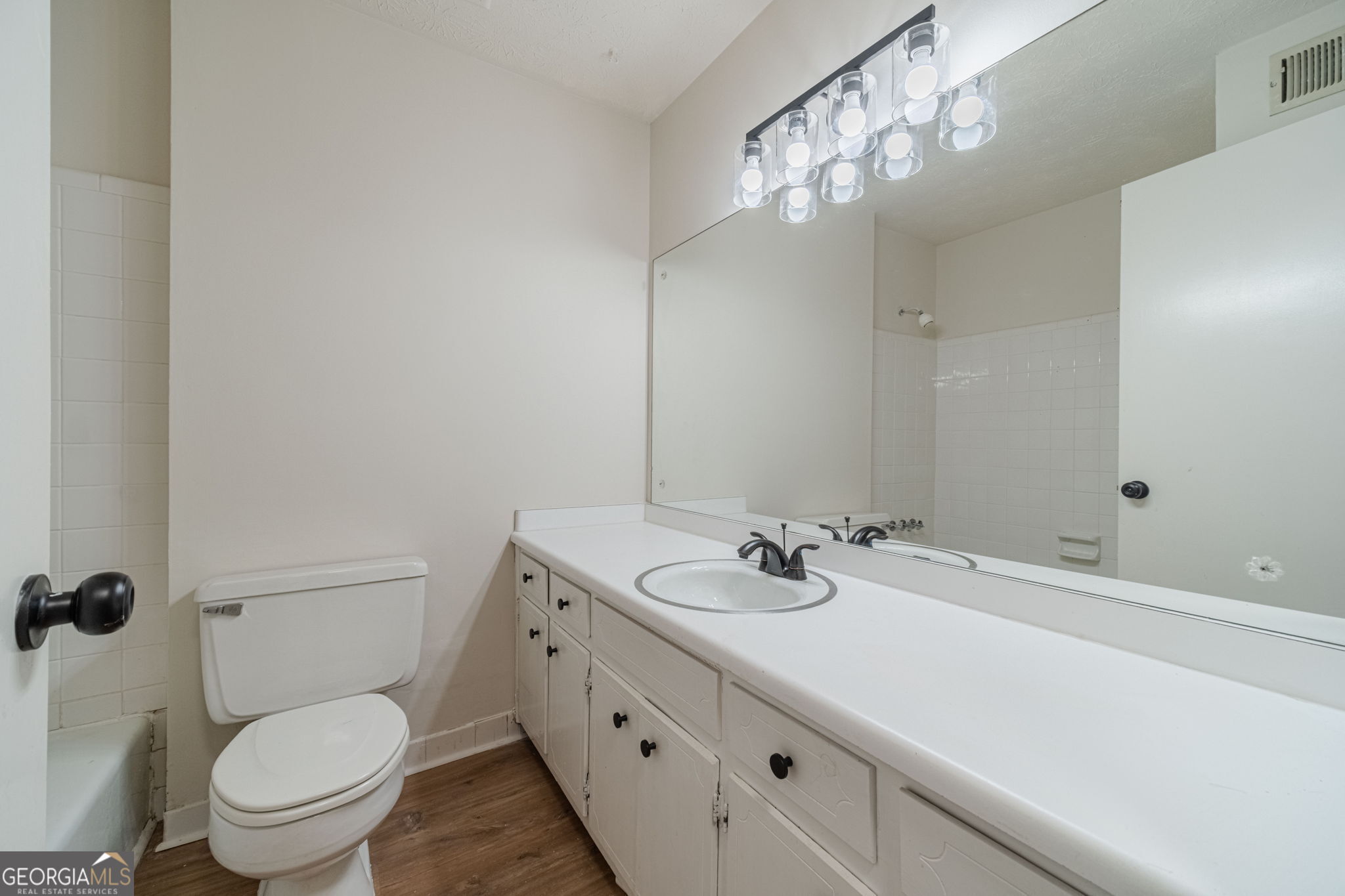 1678 Pounds Road Southwest Stone Mountain, GA 30087 - Photo 18 of 30 a bathroom with a sink a toilet and a mirror