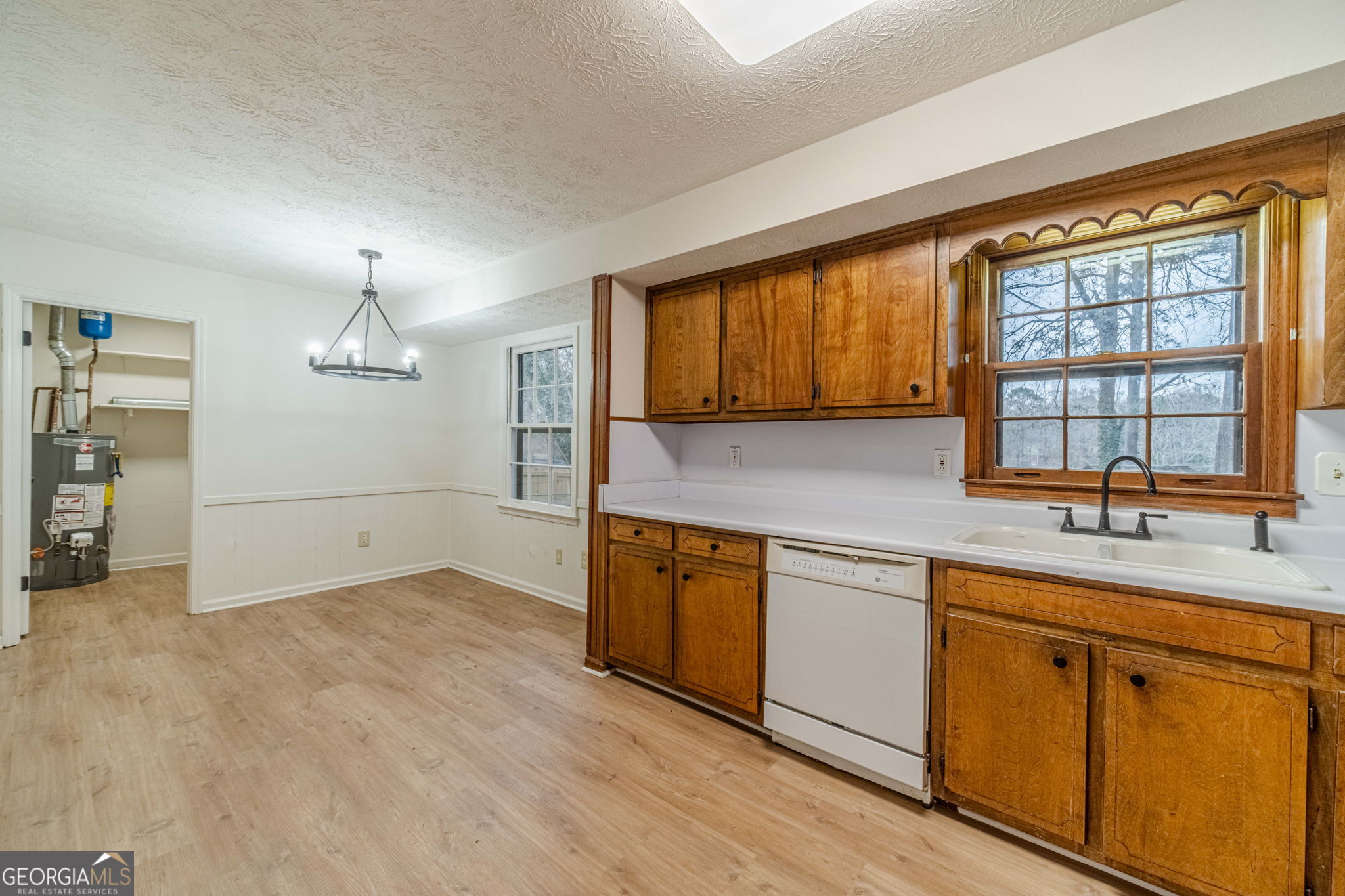 1678 Pounds Road Southwest Stone Mountain, GA 30087 - Photo 6 of 30 a kitchen with a sink cabinets stainless steel appliances and a window