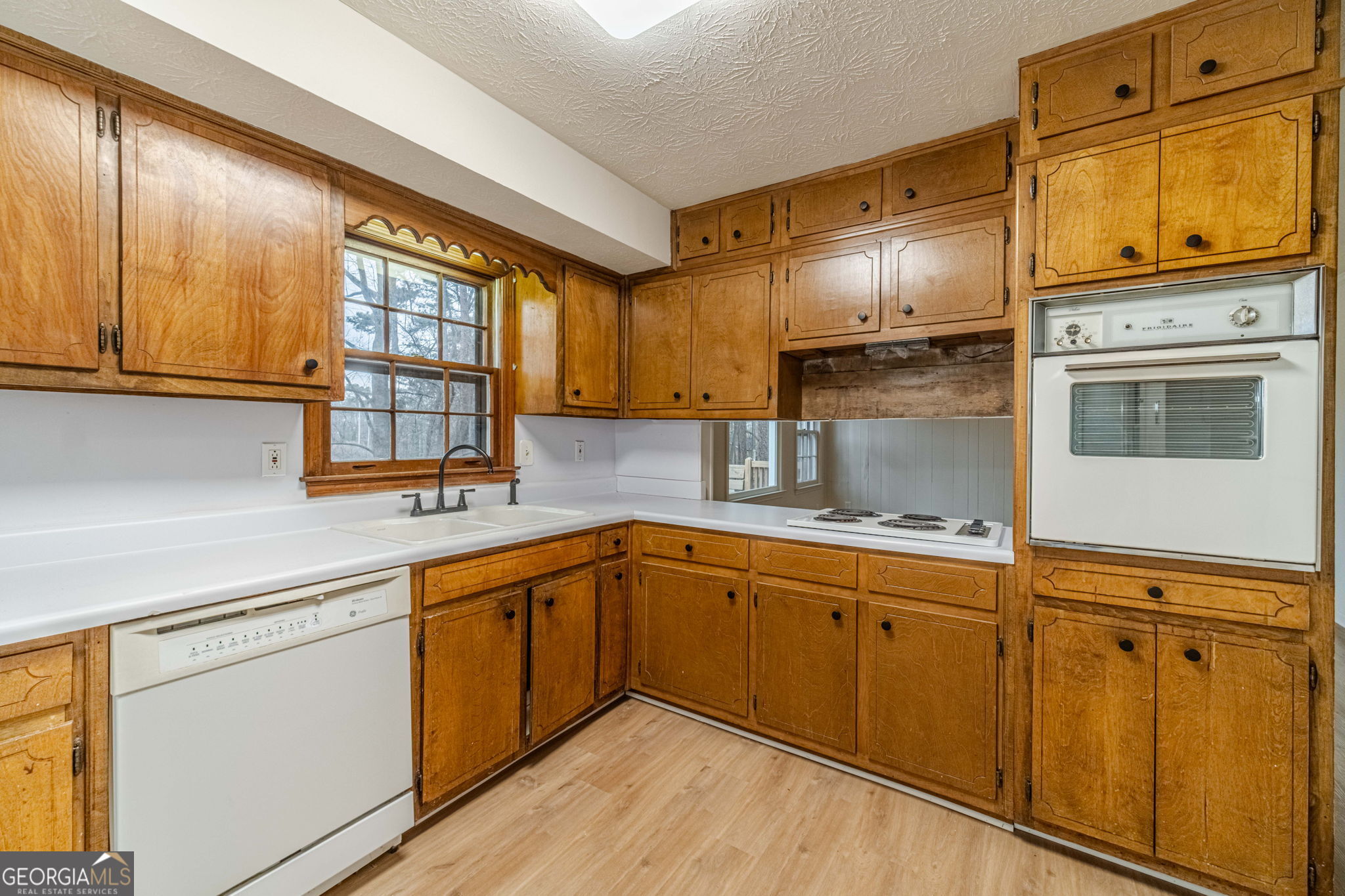 1678 Pounds Road Southwest Stone Mountain, GA 30087 - Photo 7 of 30 a kitchen with stainless steel appliances granite countertop a sink and cabinets
