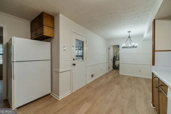 a view of empty room with wooden floor and cabinets