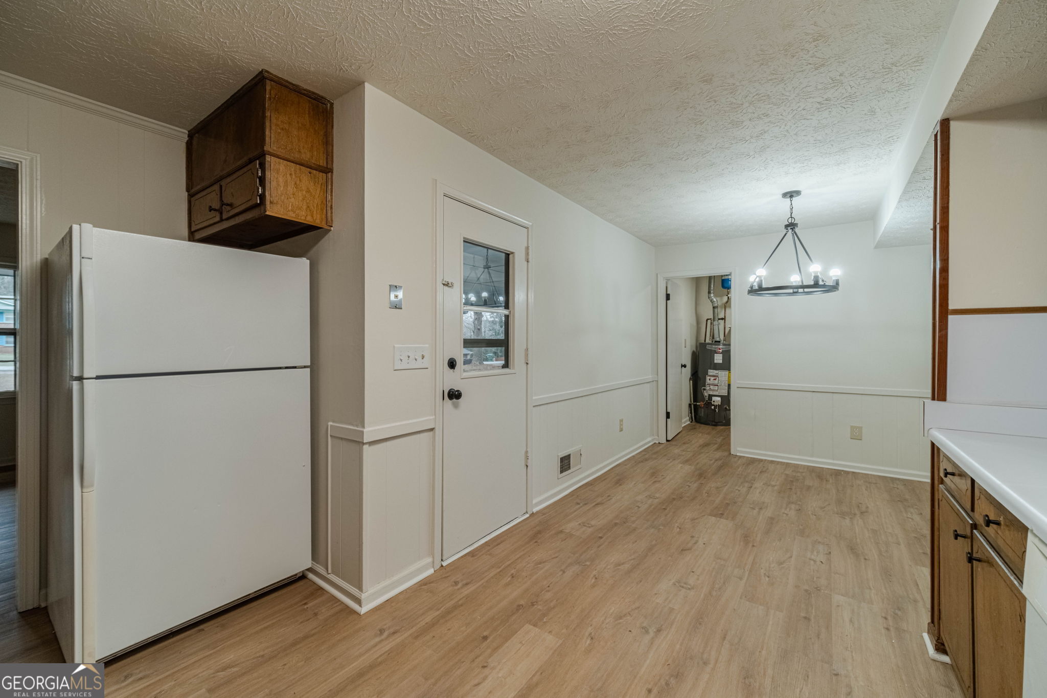 1678 Pounds Road Southwest Stone Mountain, GA 30087 - Photo 9 of 30 a view of empty room with wooden floor and cabinets