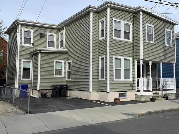 a front view of a house with a parking space