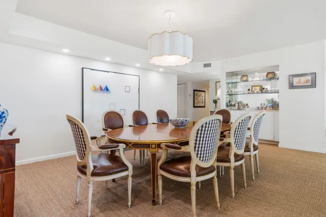 a view of a dining room with furniture and chandelier