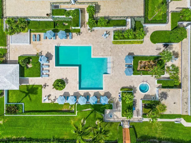 an aerial view of a house with a yard and outdoor seating