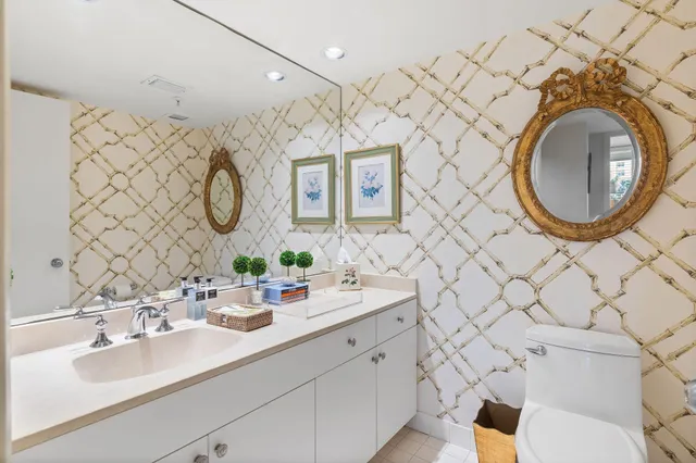 a bathroom with a sink mirror vanity and toilet