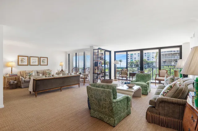 a living room with furniture and large windows