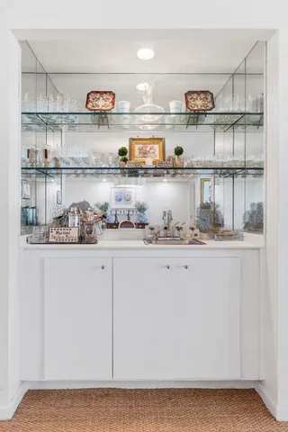 a kitchen with a lot of cabinets and wooden floor