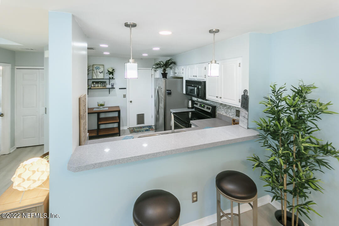 127 Sand Castle Way Neptune Beach, FL 32266 - Photo 14 of 36 a kitchen with counter space and stainless steel appliances