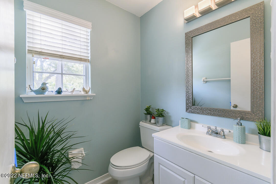 127 Sand Castle Way Neptune Beach, FL 32266 - Photo 18 of 36 a bathroom with a sink a toilet a potted plant and mirror