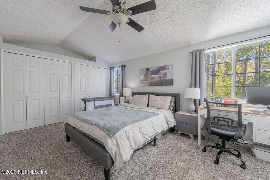 127 Sand Castle Way Neptune Beach, FL 32266 - Photo 21 of 36 a spacious bedroom with a bed a table and a window