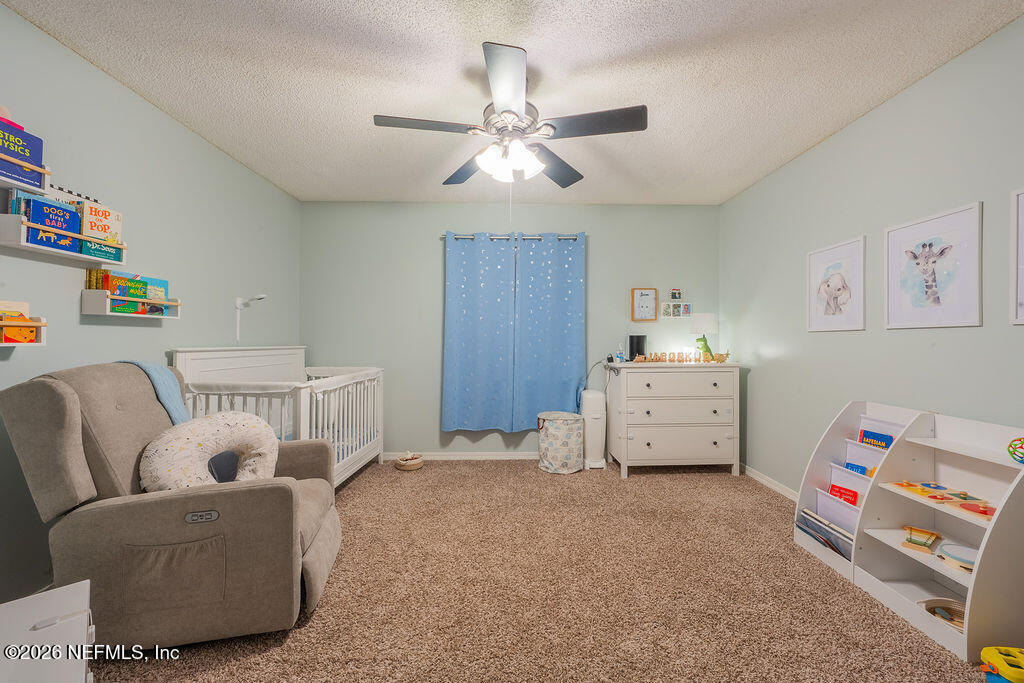 127 Sand Castle Way Neptune Beach, FL 32266 - Photo 25 of 36 a room with furniture and a chandelier fan
