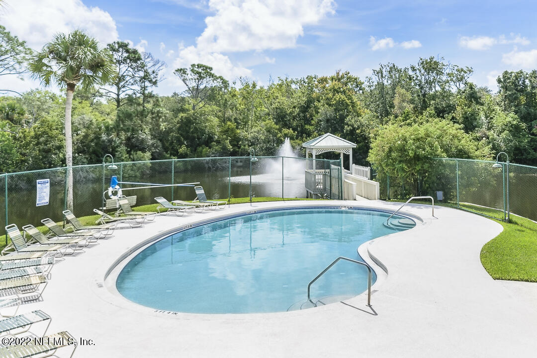127 Sand Castle Way Neptune Beach, FL 32266 - Photo 31 of 36 a view of a swimming pool with a patio