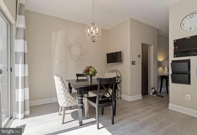 a view of a dining room with furniture and chandelier