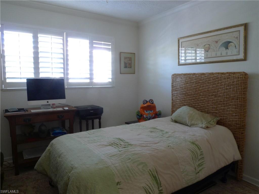 72 7th Street South, Unit 203 Naples, FL 34102 - Photo 11 of 23 a bedroom with a bed and a window