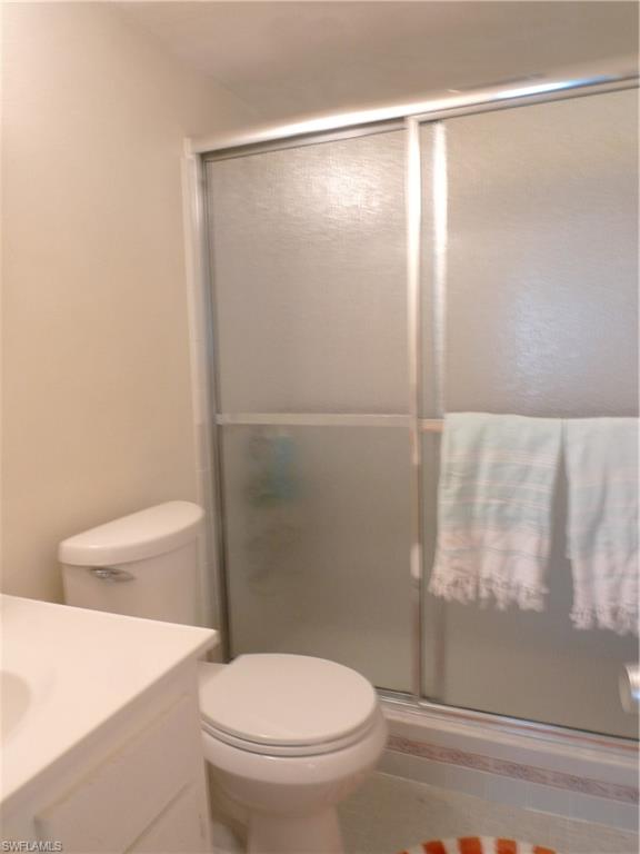 72 7th Street South, Unit 203 Naples, FL 34102 - Photo 14 of 23 a white toilet sitting next to a bathroom sink