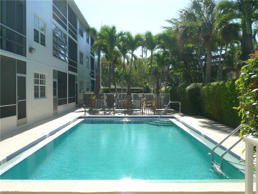 72 7th Street South, Unit 203 Naples, FL 34102 - Photo 17 of 23 a view of swimming pool with chairs