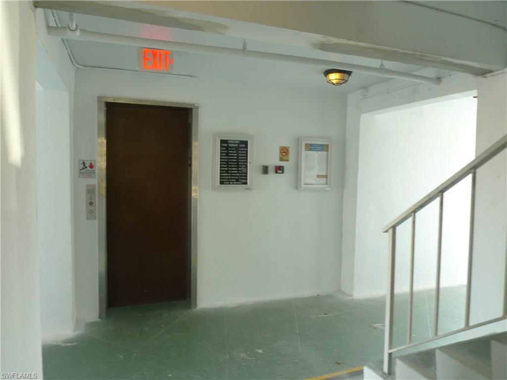 72 7th Street South, Unit 203 Naples, FL 34102 - Photo 20 of 23 a view of a hallway with wooden floor and stairs