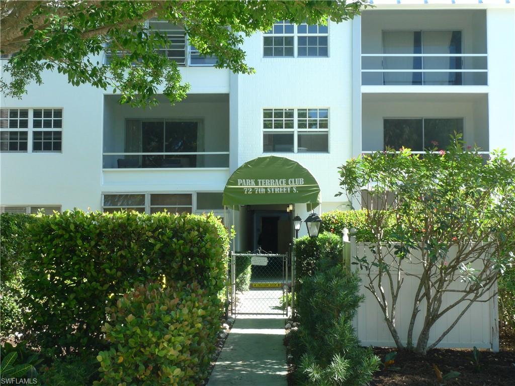 72 7th Street South, Unit 203 Naples, FL 34102 - Photo 21 of 23 a front view of a house with a garden
